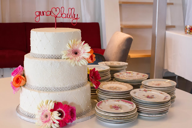 3 tiers with different color cake inside for an ombre effect. Decorates with fresh flowers, sprinkles, dragees, and crystal ribbon.