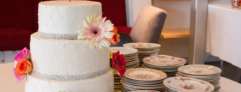3 tiers with different color cake inside for an ombre effect. Decorates with fresh flowers, sprinkles, dragees, and crystal ribbon.